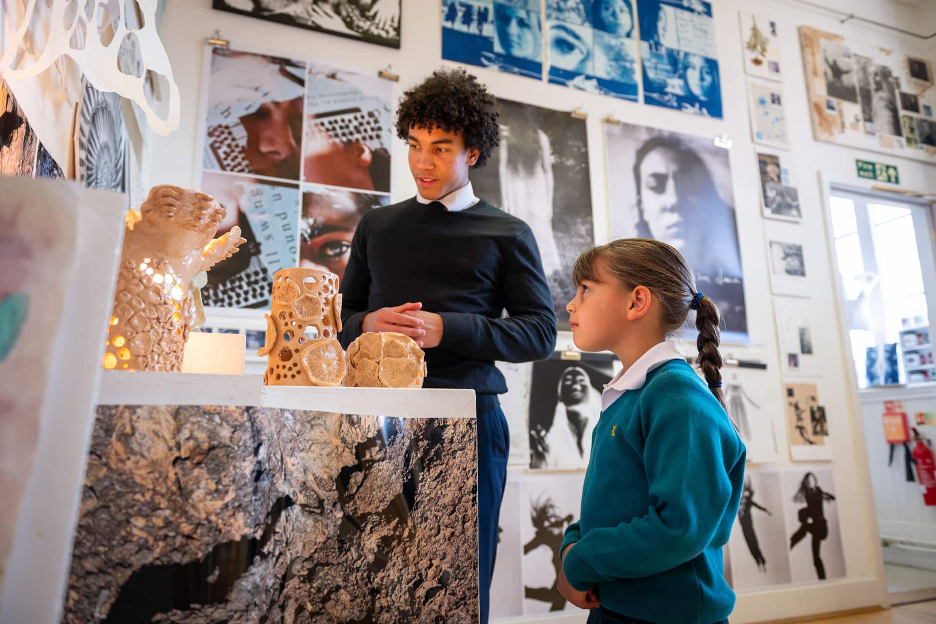 Prep school children looking at a senior school art exhibition
