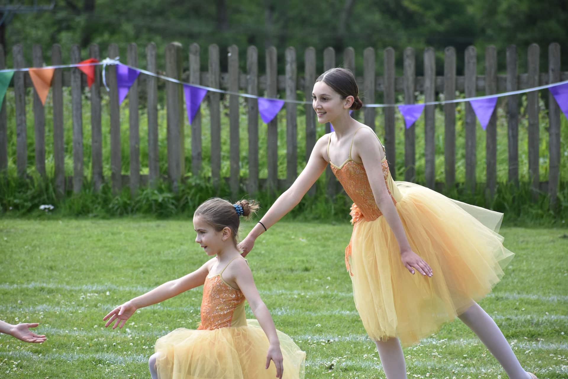 two girls dancing in tutus at a dance festival