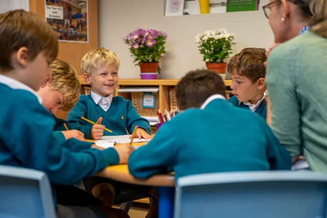 Prep children smiling at their teacher in a lesson