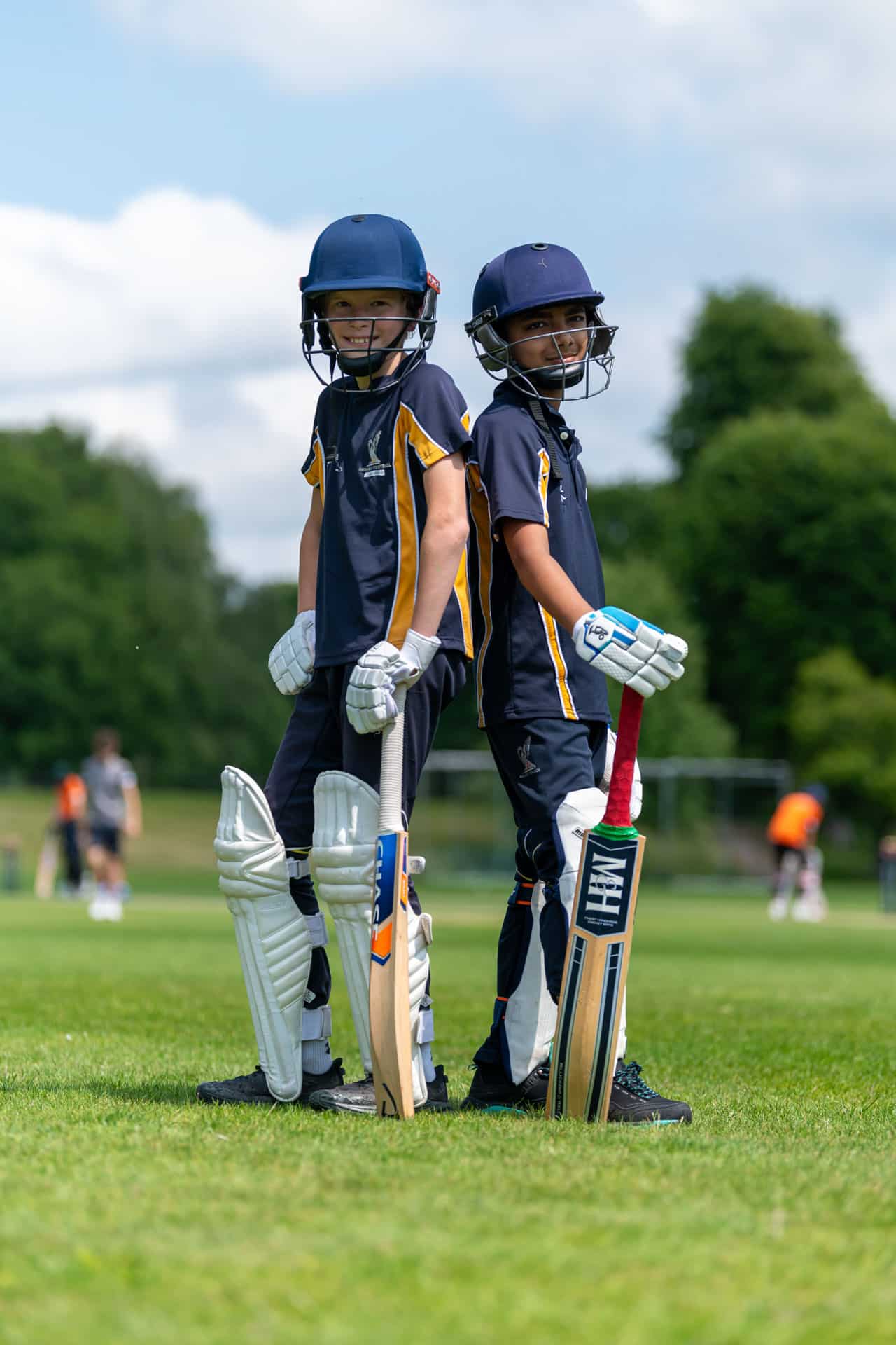Prep boys standing back to back in cricket gear