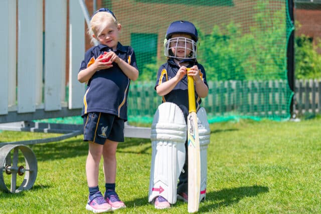Prep children trying on bigger children's cricket gear