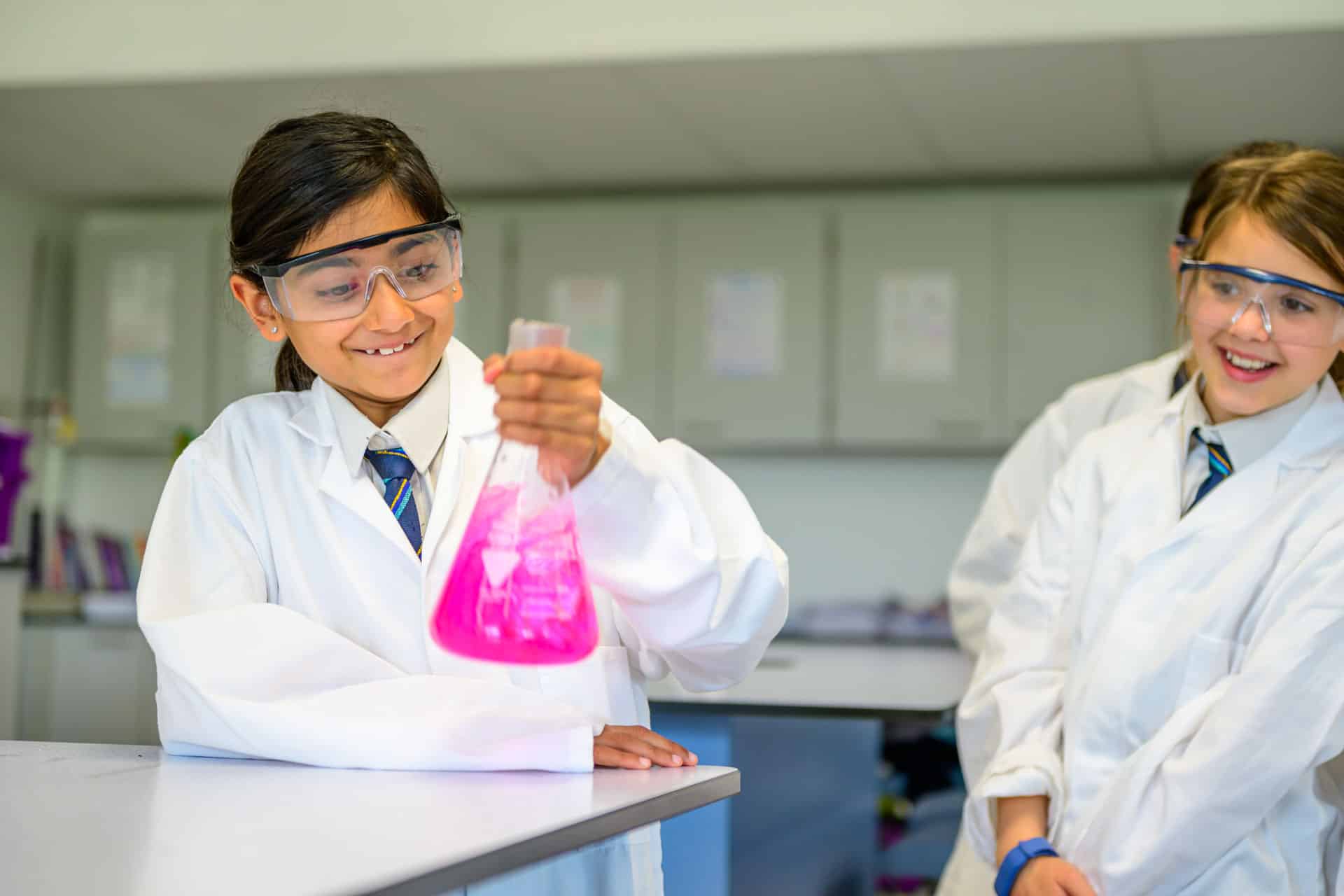 Girl holds a flask in a science lab