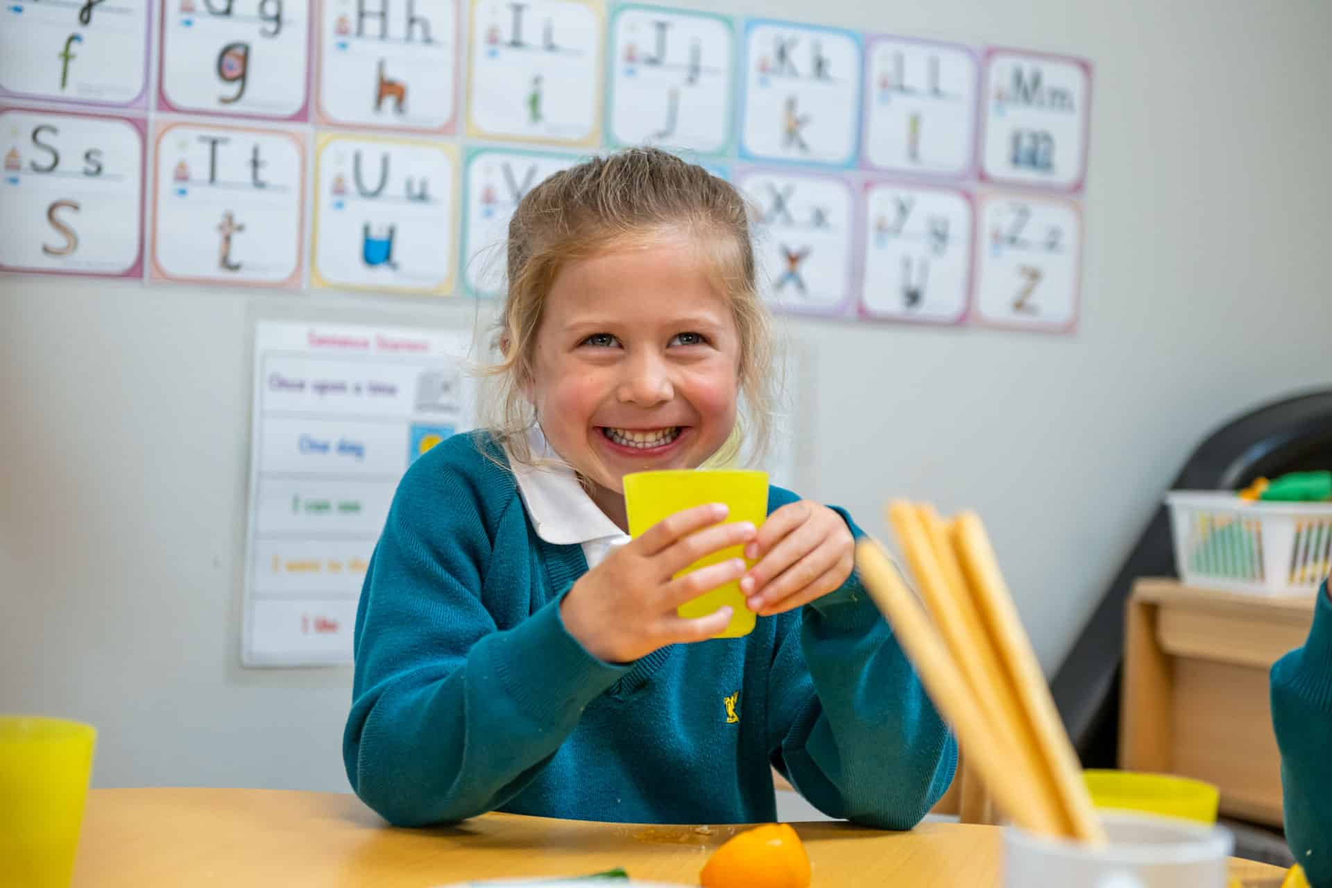 Prep child drinking from a cup
