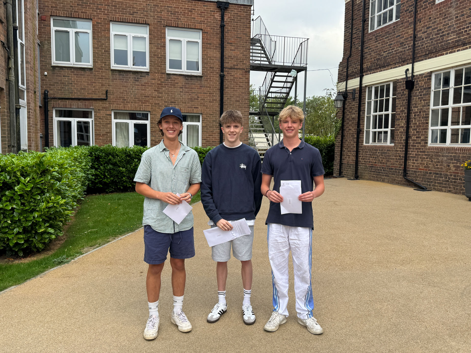 Three smiling Old Ardinians outside the Science labs having picked up their A level results