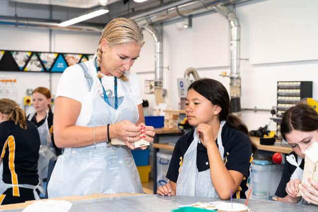 Student being shown how to do DIY