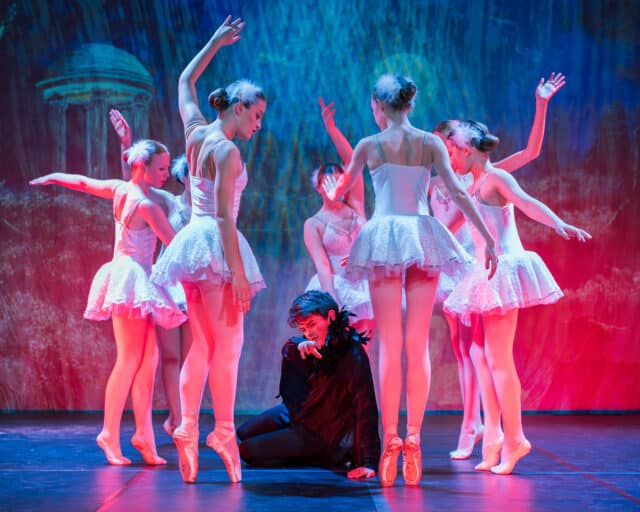 Male dancer performs surrounded by female dancers in, Lost in Motion 2025.
