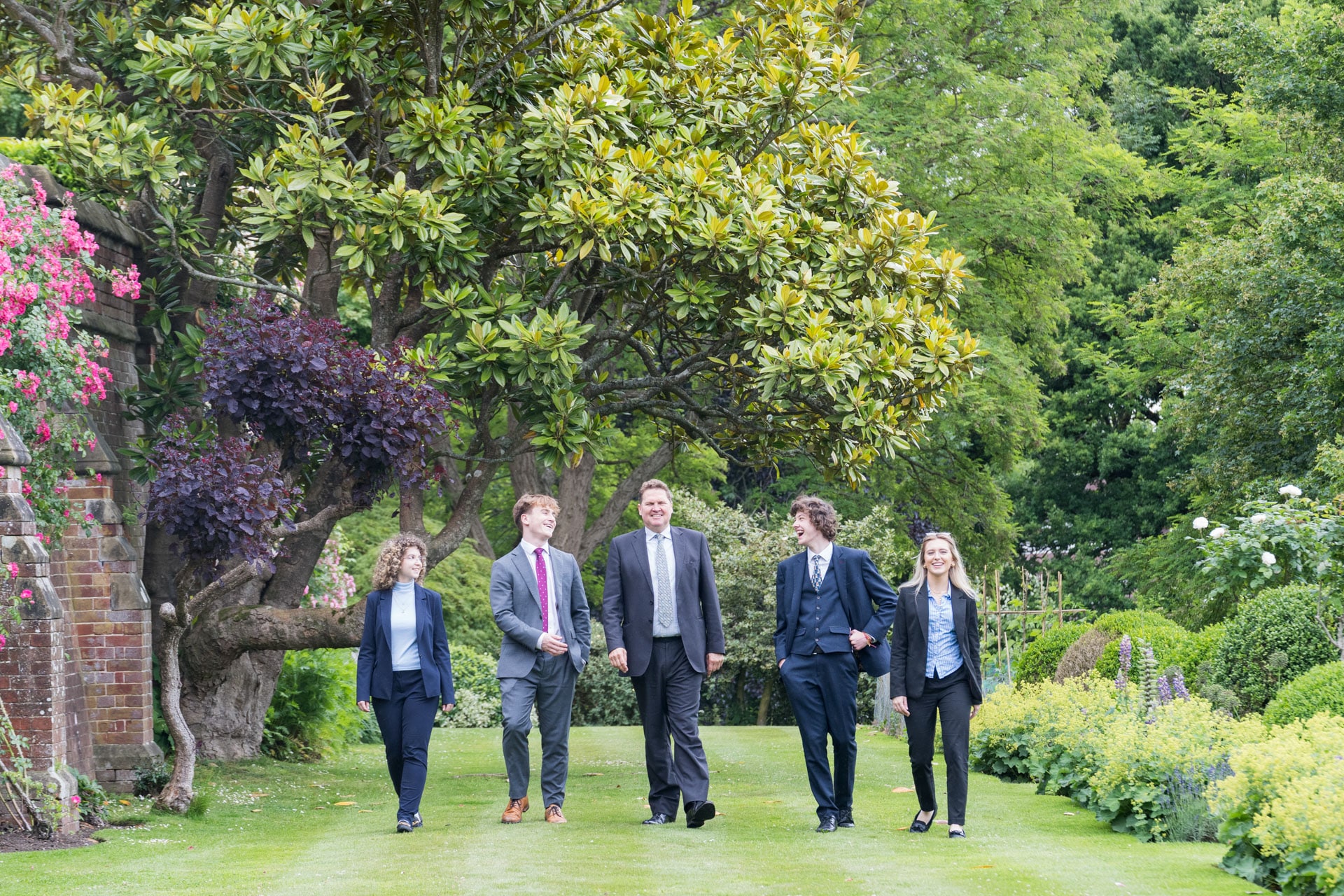 The Headmaster walking along chatting to prefects