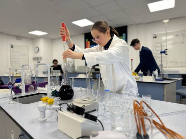 Female Sixth Form student conducting an experiment on Chemistry Day.