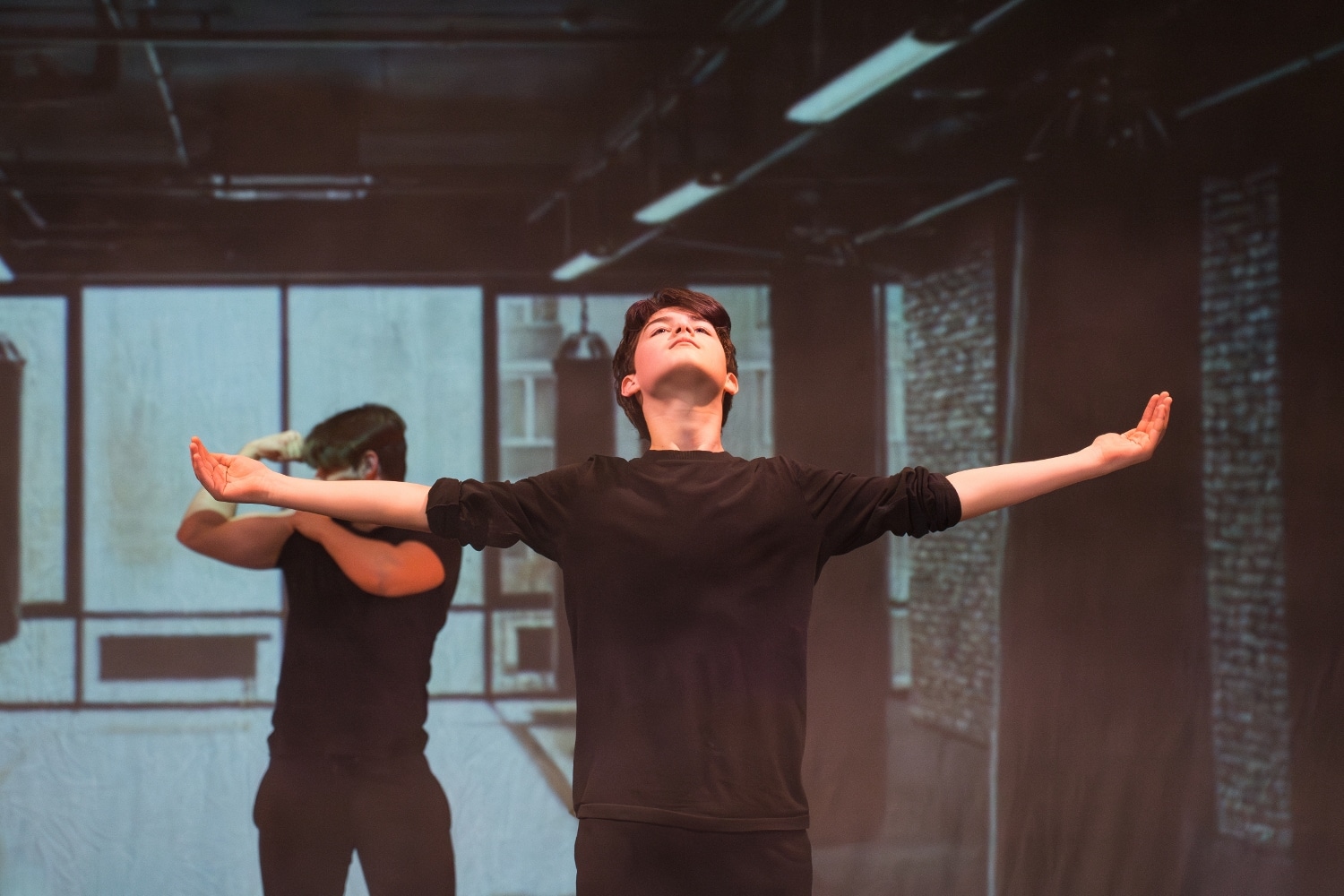 A boy dancer in black clothing