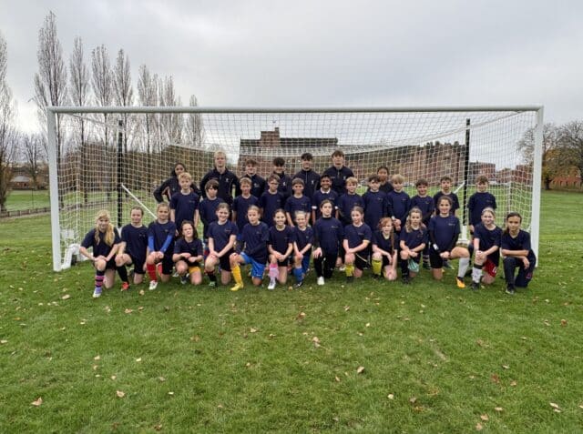 Boys' and Girls' in front of a goal at a football masterclass