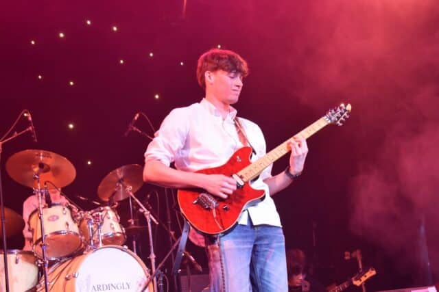A students playing the lead guitar at ABC concert