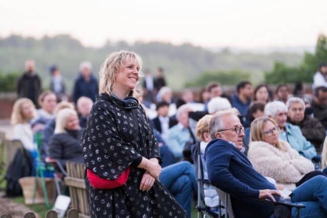 Audience watching the Summer Concert with reflective expressions